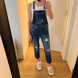 Distressed denim overalls